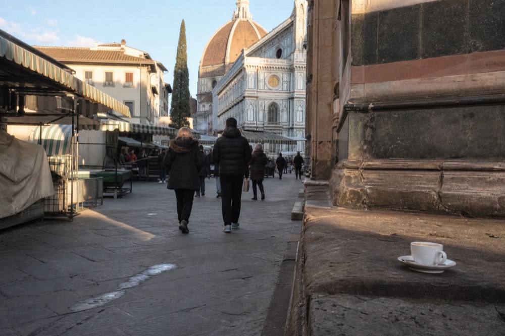 Sunlit Florentine piazza with market awnings and stone facades