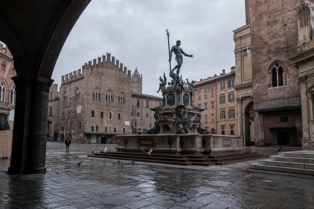 Bologna Piazza Maggiore with the Neptune fountain and red brick buildings