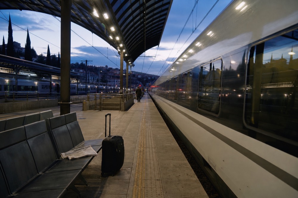 High speed train platform at an Italian railway station with departure boards