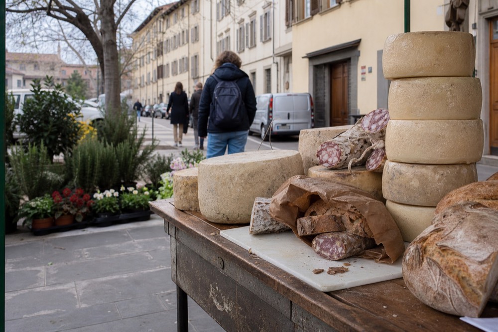 A Florence market stall with cheeses, salami and fresh bread