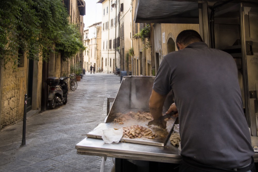 A lampredotto stall with a vendor slicing meat